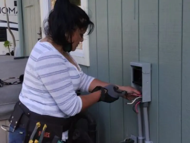 Licensed electrician wiring an exterior subpanel in Notre Dame